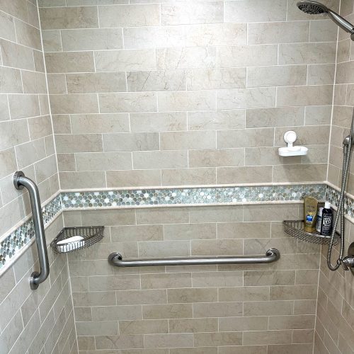 A clean bathroom featuring a modern shower and a toilet, designed for functionality and comfort.