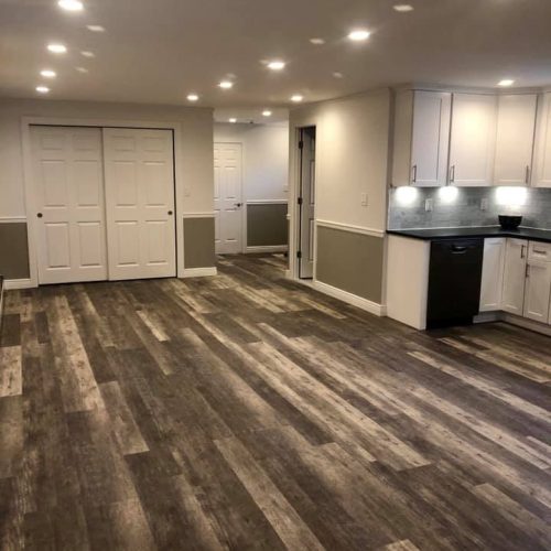 A spacious, clean basement featuring polished wood floors and an uncluttered, empty environment.